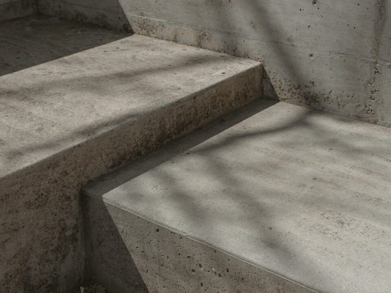 a concrete bench sitting next to a cement wall